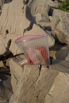 a plastic bag sitting on top of a rock