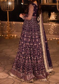 Introducing our New collection 'Chandni Raatein' by Asim Jofa designed to make you look and feel your best. Swathed in the mystique of twilight, this dress is a purple dream woven into existence. Champagne gold zari, like sunbeams kissing a lavender sky, are studded with stardust-like sequins. Threads in mauve and deep purple hues dance in harmony, creating a masterpiece of color. The embroidered dupatta, a wispy cloud of enchantment, finishes this ensemble with the grace of a fairytale ending. Embroidered Front and Back Bodice With Bodice Hem on Net Embroidered Kalis for Peshwas on Net Embroidered Border for Hemline of Peshwas on Net Embroidered Sleeves With Border on Net Embroidered Dupatta on Net With 4 Side Borders Color: There might be slight color variation due to lighting and flashe Floor-length Dresses With Dabka For Designer Wear, Dabka Floor-length Dress For Diwali, Anarkali Reception Dress With Dabka Detailing, Anarkali Dress With Dabka For Reception, Festive Long Sleeve Purple Gown, Purple Long Sleeve Festive Gown, Designer Wear Dabka Lehenga Maxi Length, Unstitched Purple Dress With Mirror Work, Eid Purple Dress With Dabka Detailing