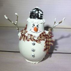 a snowman made out of an egg sitting on top of a table