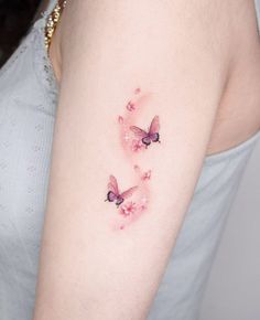 two pink butterflies on the right arm