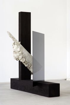 an abstract sculpture is shown in front of a white wall