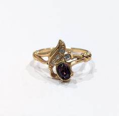 This is a vintage Avon cocktail ring from the faux amethyst collection. The ring is made of gold-tone metal and features a large purple crystal as the main stone.  Size 10 Signed Avon Great, like new condition Vintage Gold Amethyst Birthstone Ring, Vintage Gold Amethyst Ring Gift, Vintage Gold Birthstone Ring Collectible, Avon Fashion, Avon Vintage, Jewelry Purple, Ringe Gold, Ring Size 10, Purple Crystal