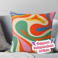 a colorful pillow with the words support independent artists on it