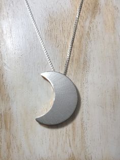 I have made a crescent Moon pendant, inspired by songstress Stevie Nicks! This piece had two sides to which the chain slides through, so you can wear it gold side, or silver side depending on mood and outfit! The entire piece is sterling silver and I 24K gold-plate overlay the other side for a less expensive alternative to solid gold, however, if you want one side to be solid 14K gold, I can do that, too. I've been a fan of Stevie Nicks since I was 6 years old and I began making my version of so Handmade Celestial Half Moon Necklaces, Handmade Celestial Half Moon Necklace, Moon Shaped Necklace With Large Pendant, Unique Crescent Moon Charm Necklace, Nickel-free Crescent Celestial Necklace, Sterling Silver Half Moon Phase Necklace, Silver Hand Forged Crescent Necklace, Symbolic Crescent Moon Phase Necklace, Hand Forged Silver Crescent Necklace