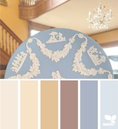 a blue plate with white lace on it and chandelier in the back ground