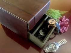 "This dresser top watch case is made of brown genuine leather by Fossil, giving it a sophisticated masculine look with stitched design. It has a top organizer with 6 sectional compartments, each with a cushion to hold the watch. The bottom has a 3-section drawer storage with brass knob to keep other accessories such as cufflinks, tie clips, and jewelry organized. The interior is lined in khaki olive army green canvas fabric. It will be a great wedding gift idea for the groom or groomsmen. Makes Brown Rectangular Watch Accessories For Formal Occasions, Formal Brown Rectangular Watch Accessories, Classic Formal Watch Accessories With Gift Box, Brown Business Watch Accessories With Case Included, Formal Brown Leather Watch Accessories, Father's Day Gift Brown Watch Accessories, Brown Watch Accessories Box As Gift, Classic Brown Watch Accessories For Gift, Business Brown Watch Accessories Box