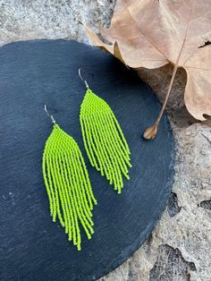 Neon yellow Beaded Fringe Earrings,Seed Bead Earrings, Boho Beaded Earrings, Bohemian Earrings, Artisan Earrings ♥𝑇ℎ𝑒 𝑝𝑎𝑡𝑡𝑒𝑟𝑛 𝑜𝑓 𝑡ℎ𝑖𝑠 𝑒𝑎𝑟𝑟𝑖𝑛𝑔 𝑖𝑠 𝑐𝑟𝑒𝑎𝑡𝑒𝑑 𝑏𝑦 𝐾𝑎𝑍𝑒𝐵𝑒𝑎𝑑𝐽𝑒𝑤𝑒𝑙𝑟𝑦 ♥𝑀𝑎𝑑𝑒 𝑢𝑠𝑖𝑛𝑔 𝑓𝑟𝑒𝑒ℎ𝑎𝑛𝑑 𝑏𝑒𝑎𝑑𝑖𝑛𝑔 𝑤𝑜𝑣𝑒𝑛 𝑡𝑒𝑐ℎ𝑛𝑖𝑞𝑢𝑒𝑠 𝑤𝑖𝑡ℎ 𝑠𝑡𝑟𝑜𝑛𝑔 𝑠𝑦𝑛𝑡ℎ𝑒𝑡𝑖𝑐 𝑡ℎ𝑟𝑒𝑎𝑑. ♥𝑇ℎ𝑒 𝑠𝑖𝑧𝑒 𝑜𝑓 𝑡ℎ𝑒 𝑠𝑒𝑒𝑑 𝑏𝑒𝑎𝑑𝑠 𝑢𝑠𝑒𝑑 𝑖𝑠 2 𝑚𝑖𝑙𝑙𝑖𝑚𝑒𝑡𝑒𝑟𝑠 𝑎𝑛𝑑 𝑏𝑒𝑎𝑑𝑠 𝑎𝑟𝑒 ℎ𝑖𝑔ℎ 𝑞𝑢𝑎𝑙𝑖𝑓𝑖𝑒𝑑. ♥𝐴𝑙𝑙 𝑡ℎ𝑒 ℎ𝑜𝑜𝑘𝑠 𝑢𝑠𝑒𝑑 𝑖𝑛 𝑜𝑢𝑟 𝑗𝑒𝑤𝑒𝑙𝑟𝑦 𝑎𝑟𝑒 24 𝑘 𝑔𝑜𝑙𝑑 𝑝𝑙𝑎𝑡𝑒𝑑 𝑎𝑛𝑑 ℎ𝑦𝑝𝑜𝑎𝑙𝑙𝑒𝑟𝑔𝑒𝑛𝑖𝑐. ♥𝑇ℎ𝑒𝑠𝑒 𝑎𝑟𝑒 𝑣𝑒𝑟𝑦 𝑙𝑖𝑔ℎ𝑡 𝑒𝑎𝑟𝑟𝑖𝑛𝑔𝑠 𝑡ℎ𝑎𝑡 𝑦𝑜𝑢 𝑐𝑎𝑛 𝑤𝑒𝑎𝑟 𝑎𝑙𝑙 𝑑𝑎𝑦 𝑤𝑖𝑡ℎ𝑜𝑢𝑡 ℎ𝑢𝑟𝑡𝑖𝑛𝑔 𝑦𝑜𝑢𝑟 𝑒𝑎𝑟! The only accessory that is not in Green Chandelier Earrings With Dangling Beads For Festivals, Yellow Beaded Earrings With Ear Wire For Festivals, Green Beaded Earrings For Festival, Handmade Lime Green Dangle Earrings, Yellow Tiny Beaded Earrings For Festival, Yellow Tiny Beads Earrings For Festival, Yellow Beaded Drop Earrings For Festival, Yellow Adjustable Earrings With Tiny Beads, Adjustable Yellow Earrings With Tiny Beads