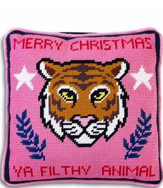 a pink pillow with a tiger face on the front and words merry christmas ya filthy animal