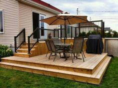 a deck with chairs and an umbrella on it