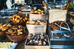 breads and pastries are on display in baskets