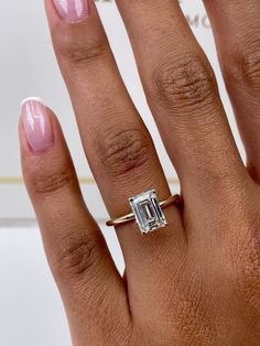 ✥ Elevate your love story to timeless elegance and ethical consciousness with our exquisite 1.79-carat emerald-cut F-color, VS-clarity lab-grown diamond engagement ring in a classic solitaire style. This ring is more than just a symbol of commitment; it's a testament to your dedication to a sustainable future. The emerald-cut diamond, renowned for its captivating elegance and distinctive step-cut facets, takes center stage, radiating with a mesmerizing sparkle and exceptional clarity that mirror the depth of your connection. The solitaire setting adds an understated sophistication, allowing the diamond's natural beauty to shine without distraction. Crafted with meticulous precision and a strong commitment to eco-conscious practices, this ring transcends mere jewelry; it's a representation Emerald Cut Small Engagement Ring, Emerald Lab Grown Engagement Ring, Emerald Engagement Ring Yellow Gold, Emerald Engagement Ring Small, White Gold Emerald Cut Engagement Ring, Engagement Rings Emerald Cut Gold, 2 Carat Emerald Engagement Rings, Emerald Engagement Ring Stack, Emerald Cut Engagement Ring With Band