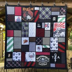 a quilt made to look like it has many different patches on it and is hanging from the side of a building