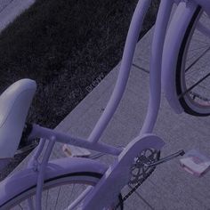 there is a purple bike parked on the sidewalk