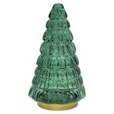 a green glass christmas tree sitting on top of a wooden base