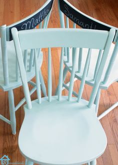 two white chairs sitting on top of a hard wood floor