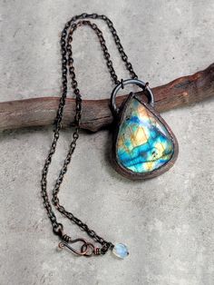 This captivating piece showcases a teardrop-shaped spectrolite labradorite, renowned for its vibrant spectrum of colors that shift with every angle, enhancing intuition and protection. Paired with a luminous rainbow moonstone, symbolizing calm and feminine energy, this necklace is a powerful talisman of inner strength and spiritual connection. Handcrafted in copper, this unique design is perfect for those seeking to add a touch of mystical elegance to their style, radiating both beauty and positive energy with every wear. One of a kind piece  Complimentary gift wrapping included Wire Wrapped Labradorite Teardrop Pendant Necklace, Labradorite Gemstone Teardrop Pendant Jewelry, Unique Labradorite Teardrop Pendant Jewelry, Wire Wrapped Labradorite Teardrop Jewelry, Handmade Labradorite Teardrop Jewelry, Nature-inspired Teardrop Necklace For Healing, Labradorite Teardrop For Jewelry Making, Labradorite Teardrop Beads For Jewelry Making, Teardrop Labradorite Necklace