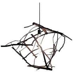 an artistic light fixture with branches hanging from it's sides and lights in the middle