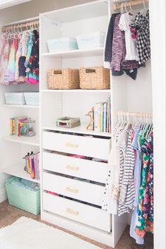 a white closet filled with lots of clothes and baskets on top of it's shelves