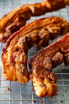 several pieces of meat sitting on a cooling rack