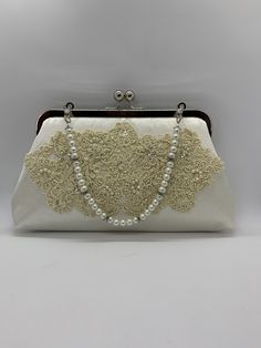 This gorgeous clutch purse was custom made using an old wedding dress that the customer provided  with Glass pearl handle  #fashion #wedding #clutch #zbesties #custommade #bridal #purses #bride2019 #jemdesign567 Elegant Cream Bag For Ceremony, Elegant Cream Bag For Ceremonies, Vintage Wedding Clutch Bag, Cream Rectangular Evening Bag For Wedding, Cream Clutch For Wedding, Elegant White Evening Bag For Vintage Events, Cream Rectangular Evening Bag For Weddings, Vintage Cream Bag For Wedding, Vintage Cream Bags For Weddings