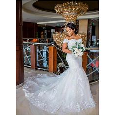 a woman in a white wedding dress holding a bouquet