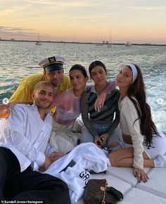 a group of people sitting on top of a boat