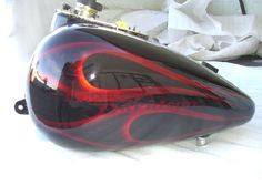 a black and red motorcycle with flames painted on it