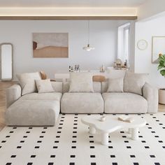 a living room with white furniture and black and white flooring