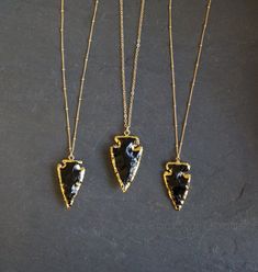 "Raw black Obsidian arrowhead pendants edged in gold on a custom length Gold Filled chain. These are natural stones so each arrowhead will vary slightly in shape and size. Obsidian has strong metaphysical properties to protect you from negativity, and is very useful to help you to let go of disharmony that has accumulated from your day to day life. Obsidian rock forms from molten lava that cooled very quickly and had no time to form into glass. It is said to be a type of volcanic glass, and is f Gold Spiritual Obsidian Jewelry, Gold Obsidian Jewelry As A Gift, Handmade Black Arrowhead Jewelry, Handmade Black Arrowhead Necklace, Obsidian Rock, Raw Obsidian, Obsidian Meaning, Chakra Stones Healing Crystals, Black Obsidian Necklace