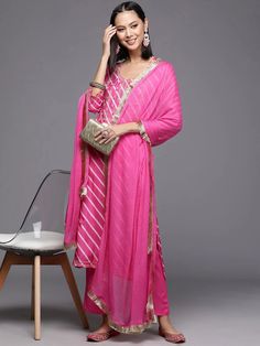 Grab this beautiful 3-piece set. The set comes with leheriya print & embroidery detailing kurta has round neck, 3/4th sleeves & calf length teamed with solid pink trouser pant with elasticated waistband and a slip-on closure and a solid silk chiffon dupatta with lace detailing. Color - Pink Kurta Fabric-Cotton Bottom Fabric-Cotton Dupatta Fabric - Silk Chiffon Neck-Round Neck Sleeves-3/4th Sleeves Work - Leheriya Print & Embroidery Detailing Washing Instructions-Hand Wash DISCLAIMER - The color of the product may be differ due to screen settings of device. A misprint here and a color drop slip there is the beauty of printing which is not treated as a defect. Pink Kurta, Embroidered Suit, Formal Jewelry, Pink Trousers, Print Embroidery, Embroidery Detailing, Cotton Dupatta, Chiffon Dupatta, Cotton Bottoms