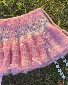 a cute pink knitted skirt with bows laying on some grass on a sunny day 2000s Crochet Fashion, Crochet Ruffles Pattern, Crochet Skirt Maxi, Sewing Projects Clothes Aesthetic, Crochet Net Skirt, Cute Crochet Clothing, Kandi Skirt, Crochet Gradient, Crochet Ruffle Skirt