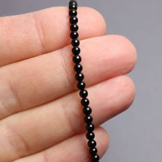 "Black Onyx beads are hand strung to form this classic single strand bracelet. The beads are tiny measuring about 3.0mm. This is a beautifully tiny, and delicate onyx bracelet. You could wear this alone or stack with other bracelets for a layering effect. I have hand strung these beads using a premium beading wire that has beautiful drape and it fastens with a sterling silver or gold filled lobster clasp. The bracelet is available in 6.0\" to 8.0\" lengths. Select your size at check out. Matchin Minimalist Onyx Beaded Bracelets With Round Beads, Minimalist Onyx Beaded Bracelet With Round Beads, Minimalist Single Strand Beaded Bracelet, Minimalist Single Strand Beaded Bracelets With Round Beads, Spiritual Single Strand Bracelet With Round Beads, Single Strand Beaded Bracelets For Jewelry Making, Sterling Silver Bead Bracelet, Black Onyx Bracelet, Black Beaded Bracelets