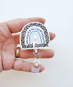 This cute Medical Assistant rainbow Badge Reel measures aprox 2 inches. It is printed on a very premium white acrylic, And is attached to a retractable badge reel Available in Alligator, Belt, or Carabiner The standard Alligator and belt Clip badges can handle up to 3 ounces of weight. Putting too much weight on these badges will cause the Reel to losen and not function properly. If you want to add items to your badge that you know will weigh more than 3 ounces, the Carabiner Badge Reel can hand Adjustable White Badge Holder For Personal Use, Customizable White Badge Holders For Personal Use, Customizable Adjustable White Badge Holders, Adjustable Customizable White Badge Holders, Customizable White Badge Reel, Pioneer School Gifts, Rainbow Badge, Alligator Belt, Hospice Nurse