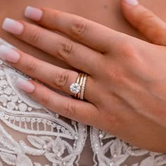 a close up of a person's hand with a wedding ring on their finger