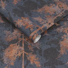 an orange and blue wallpaper with trees in the background on a dark gray surface