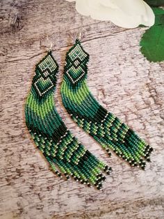 Green Beaded Earrings For Festival, Handmade Green Beaded Earrings For Festivals, Handmade Green Tassel Earrings For Festival, Green Long Drop Jewelry With Dangling Beads, Green Tassel Earrings With Fringe For Festivals, Handmade Green Tassel Earrings For Gift, Adjustable Green Tassel Earrings, Green Bohemian Beaded Dangle Earrings, Unique Green Beaded Dangling Earrings