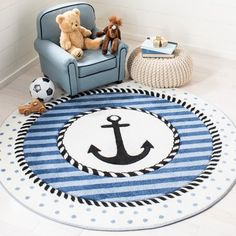 a child's room with a blue chair, teddy bears and an anchor rug