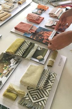 a table topped with lots of different types of fabrics