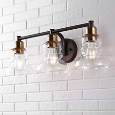 Elevate your urban interior with our modern take on a classic wall light; The industrial Edison-style LED bulb casts a warm glow, providing plenty of light; A clear glass bell shade adds elegant vintage style to your bath vanity, kitchen, hallway or entry; JONATHAN Y Manhattan Vintage Metal/Glass Industrial Rustic 25.5-in 3-Light Satin Gold LED Farmhouse Vanity Light | JYL3546A Classic Wall Light, Farmhouse Vanity Lights, Classic Wall Lights, Brass Vanity Light, Farmhouse Vanity, Led Vanity Lights, Urban Interiors, Classic Wall, Led Vanity