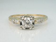 an antique diamond engagement ring with three diamonds