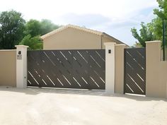 a house with a fence and gate in front of it