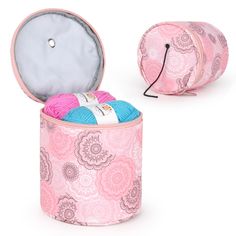 a pink and blue container with yarn inside it on a white surface next to another bag