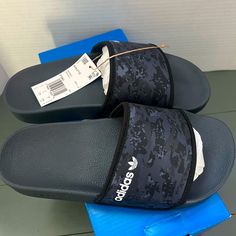 Brand New With Tags And Original Box. Adult Adidas Black Camo Slip On Slides In Size Us 6. You Know Them. You Love Them. They're The Adidas Adilette Slides. An Instantly Recognizable Classic That's Been Around Since 1972, The Og Slide Continues To Be Seen Everywhere From The Beach To The Locker Room, And On Everyone From Athletes To Celebrities. This Version Combines Camo With The Iconic Adidas 3-Stripes. Gray Synthetic Slip-on Slides, Non-slip Gray Synthetic Slides, Casual Gray Synthetic Sandals, Casual Gray Open Toe Slides, Gray Synthetic Slides For Summer, Casual Gray Sandals With Textured Footbed, Black Adidas Slide Sandals, Adidas Black Slip-on Slides, Gray Slip-on Synthetic Slides