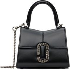 Coated buffed leather top handle bag in black. · Rolled carry handle · Detachable curb chain crossbody strap · Curb chain logo hardware at face · Logo plaque at back face · Bumper studs at base · Magnetic foldover flap · Two card slots at interior · Grained leather interior · Faille lining · Logo-engraved silver-tone hardware · H6 x W7 x D4 Supplier color: Black/Silver Mini Top Handle Bag, Chain Logo, Marc Jacobs Tote, Face Logo, Mini Top, Jacob Black, Marc Jacobs Bag, Silver Engraving, Mini Shoulder Bag