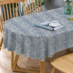 a blue and white table cloth on top of a wooden chair next to a potted plant