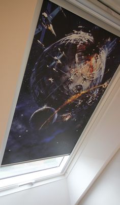 an image of a space scene on the ceiling in a room with a skylight