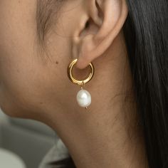 Meet our Becca Medium Pearl Hoops, a timeless and versatile piece. These classic chunky hoops feature a detachable freshwater pearl charm, making each piece truly unique with its own nuances, luster, tone, and shape. Crafted from jewelry-grade stainless steel, these hoops are hypoallergenic, tarnish-resistant, and waterproof, ensuring durability and comfort for everyday wear. Embrace the beauty of individuality! Details: Gold: 316L Stainless Steel, 18K Gold PVD Plated, Freshwater Pearls Silver: Classic Metal Pearl Earrings With Pearl Charm, Modern Everyday Pearl Drop Jewelry, Modern Jewelry With Pearl Charm, Modern Pearl Hoop Jewelry, Modern Hoop Jewelry With Pearl Charm, Modern Hoop Pearl Jewelry, Modern Pearl Jewelry With Pearl Charm, Modern Pearl Charm Jewelry, Modern Teardrop Jewelry With Pearl Charm