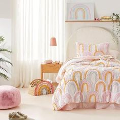 a bedroom with white walls and pink bedding on the floor next to a window