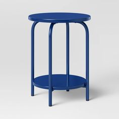 a blue side table with a round top and metal legs, on a white background