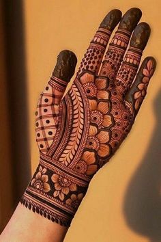 a woman's hand with henna on it